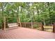 Inviting back deck features a wooden swing and overlooks a lush, green backyard at 1858 De Winton Pl, Lawrenceville, GA 30043