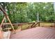 Inviting back deck features a wooden swing and overlooks a lush, green backyard at 1858 De Winton Pl, Lawrenceville, GA 30043