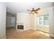 Comfortable bedroom featuring a fireplace, neutral walls, carpet, and a ceiling fan at 1858 De Winton Pl, Lawrenceville, GA 30043