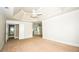 Spacious bedroom featuring neutral walls, carpet, tray ceiling with fan, and multiple windows at 1858 De Winton Pl, Lawrenceville, GA 30043