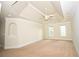 Large bedroom featuring neutral walls, carpet, tray ceiling with fan, and windows for natural light at 1858 De Winton Pl, Lawrenceville, GA 30043