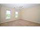 Comfortable bedroom with neutral walls, carpet, two windows for natural light, and a ceiling fan at 1858 De Winton Pl, Lawrenceville, GA 30043