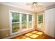 Bright breakfast nook with hardwood floors, large windows offering views of the landscaped backyard, and a cabinet at 1858 De Winton Pl, Lawrenceville, GA 30043