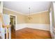 Elegant dining room featuring hardwood floors, decorative molding, and a chandelier for formal dinners at 1858 De Winton Pl, Lawrenceville, GA 30043