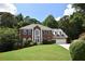 Charming brick home with arched window, well-maintained lawn, and an attached two car garage at 1858 De Winton Pl, Lawrenceville, GA 30043