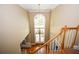 Elegant foyer featuring hardwood floors, a chandelier, and a large arched window for ample natural light at 1858 De Winton Pl, Lawrenceville, GA 30043