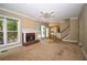Open-concept living room with a cozy fireplace, access to the deck, and seamless flow into the adjacent kitchen area at 1858 De Winton Pl, Lawrenceville, GA 30043