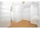 Bright walk-in closet featuring white shelving and a neutral carpet, providing ample storage space at 1858 De Winton Pl, Lawrenceville, GA 30043