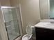 Bathroom featuring a glass-enclosed shower and a toilet next to a vanity at 2423 Turnbury Glen Walk, Snellville, GA 30078