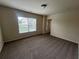 Neutral bedroom featuring carpet, a window with blinds, and an adjacent doorway at 2423 Turnbury Glen Walk, Snellville, GA 30078