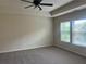Bright bedroom featuring a tray ceiling, neutral carpeting, and large windows offering natural light at 2423 Turnbury Glen Walk, Snellville, GA 30078