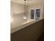 Second story hallway with bright natural light, a modern chandelier, and neutral paint providing an open airy feel at 2423 Turnbury Glen Walk, Snellville, GA 30078