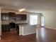 Spacious kitchen with granite countertops, an island, stainless steel appliances, and hardwood flooring at 2423 Turnbury Glen Walk, Snellville, GA 30078
