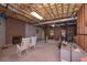 Unfinished basement featuring exposed ceilings, brick fireplace, and ample space for customization at 3743 Johnston Rd, Winston, GA 30187