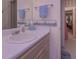 Bathroom vanity with sink, mirror, and floral wallpaper, offering a clean and bright space at 3743 Johnston Rd, Winston, GA 30187