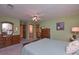 Spacious bedroom with light green walls, ceiling fan and three large dressers at 3743 Johnston Rd, Winston, GA 30187