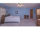 Spacious bedroom with light blue walls, with views to a bathroom at 3743 Johnston Rd, Winston, GA 30187
