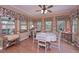 Bright breakfast nook with hardwood floors, many windows and decorative floral valances at 3743 Johnston Rd, Winston, GA 30187