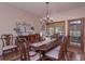 Traditional dining room with hardwood floors, wooden table with matching chairs and decorative chandelier at 3743 Johnston Rd, Winston, GA 30187