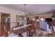 Open concept dining room leading to living room with decorative area rug and a view to the kitchen at 3743 Johnston Rd, Winston, GA 30187