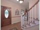 Inviting foyer with hardwood floors, staircase, and decorative front door with oval glass insert at 3743 Johnston Rd, Winston, GA 30187