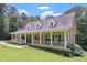Charming home features a covered front porch, well-manicured lawn, and beautiful landscaping at 3743 Johnston Rd, Winston, GA 30187