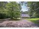 Beautiful home with a long driveway, mature trees, and inviting front porch for relaxing at 3743 Johnston Rd, Winston, GA 30187