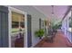 Long front porch showcasing ample seating, plants, and charming architectural details at 3743 Johnston Rd, Winston, GA 30187