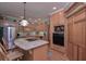 Well-equipped kitchen with an island cooktop, stainless steel appliances and light wood cabinets at 3743 Johnston Rd, Winston, GA 30187