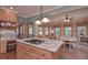 Spacious kitchen island with cooktop, light wood cabinets, stainless steel appliances and adjoining breakfast nook at 3743 Johnston Rd, Winston, GA 30187