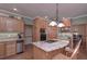 Well-equipped kitchen with an island cooktop, stainless steel appliances and light wood cabinets at 3743 Johnston Rd, Winston, GA 30187