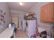 Functional laundry room with washer and dryer and plenty of storage space at 3743 Johnston Rd, Winston, GA 30187
