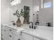 Bathroom featuring double sinks, quartz countertops, modern fixtures and tile at 89 Batten Board Way, Woodstock, GA 30189