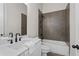 Modern bathroom with white vanity, dark fixtures, and tiled shower-tub combination at 89 Batten Board Way, Woodstock, GA 30189