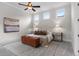 Comfortable bedroom with ceiling fan, three windows, and stylish decor at 89 Batten Board Way, Woodstock, GA 30189