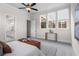 Bedroom featuring a leather bench, a view of the bathroom, and large bright windows at 89 Batten Board Way, Woodstock, GA 30189