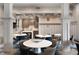 Open concept dining area featuring modern tables, chairs, and an adjacent kitchenette for easy entertaining at 89 Batten Board Way, Woodstock, GA 30189