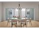 Elegant dining area features a glass-top table, stylish chairs, and a modern chandelier at 89 Batten Board Way, Woodstock, GA 30189