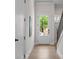 Bright entryway with wood floors and a glass door, leading to the home's interior at 89 Batten Board Way, Woodstock, GA 30189