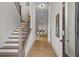 Inviting entryway with hardwood floors, staircase, and view of the dining room with modern chandelier at 89 Batten Board Way, Woodstock, GA 30189