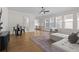 Open concept living room with hardwood floors, modern furnishings, and great natural light at 89 Batten Board Way, Woodstock, GA 30189