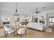 Open-concept living area with dining space, fireplace, and a modern kitchen at 89 Batten Board Way, Woodstock, GA 30189