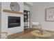 Cozy living room with modern fireplace, wood mantel, and comfortable seating at 89 Batten Board Way, Woodstock, GA 30189