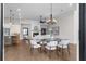 Open floor plan showcases a dining area and a living room with a fireplace at 89 Batten Board Way, Woodstock, GA 30189