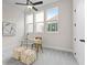 Bright office space featuring a glass desk, neutral carpet, three windows, and modern decor at 89 Batten Board Way, Woodstock, GA 30189