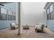 Relaxing outdoor patio with comfortable seating, patterned rug, and stylish decor at 89 Batten Board Way, Woodstock, GA 30189
