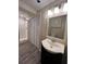Nicely finished bathroom with updated shower, vanity, mirror and plank flooring at 11800 Carriage Park Ln, Johns Creek, GA 30097