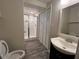 This bathroom has updated vanity, sink, and commode next to a tiled walk-in shower at 11800 Carriage Park Ln, Johns Creek, GA 30097