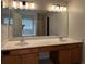 Bathroom featuring double sink vanity, tub, and lots of light at 11800 Carriage Park Ln, Johns Creek, GA 30097