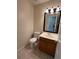 Half bath with pedestal sink, tile flooring, and updated lighting at 11800 Carriage Park Ln, Johns Creek, GA 30097